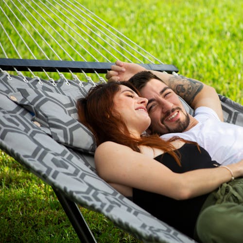 Couple laying in the 55-inch Hexagonal Quilted Hammock.