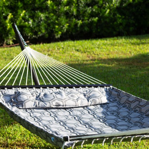 Depth of field shot of the 55-inch Hexagonal Quilted Hammock in the sun.