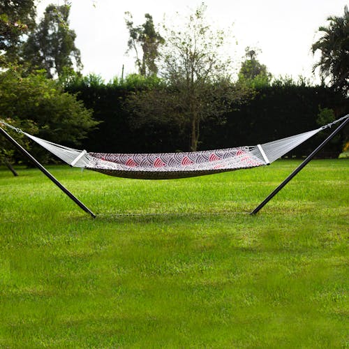 55-inch Red and Grey Quilted Hammock secured to a stand on grass.