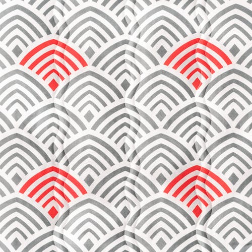 Close-up of the fabric and pattern, showing the white hammock with a grey and red arch pattern.