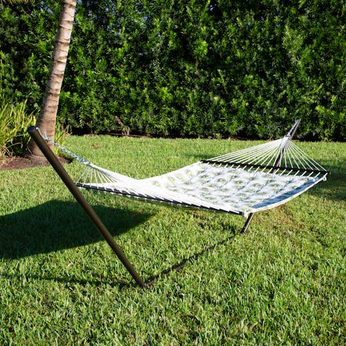 55-inch Green Burst Quilted Hammock secured to a stand on grass.