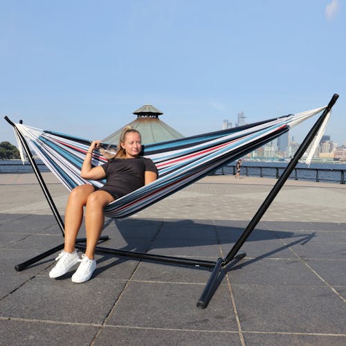 Girl sitting in the 60-inch America's Cup Hammock and Stand.