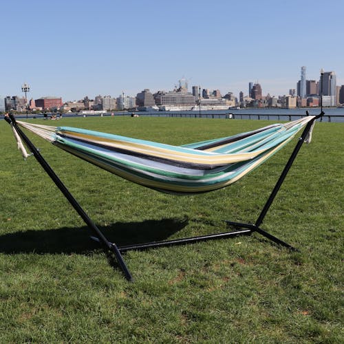 60-inch Country Club Hammock and Stand on grass with the New York skyline in the background.