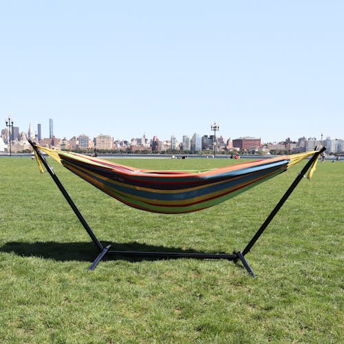 60-inch Candy Stripe Hammock and Stand on grass with the New York skyline in the background.