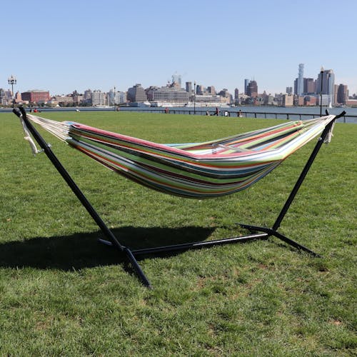 60-inch tropical fruit hammock and stand on grass with the New York skyline in the background.