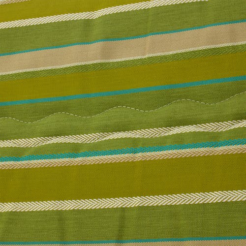 Close-up of the fabric and pattern, showing the different shades of green stripes.
