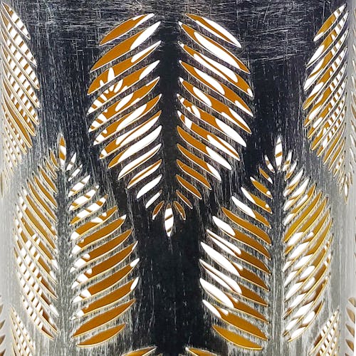 Close-up of the silver hand-painted finish and tropical leaf pattern.