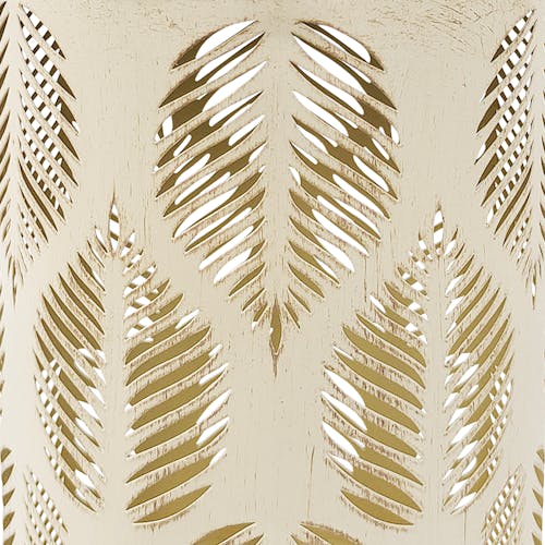 Close-up of the antique white hand-painted finish and tropical leaf pattern.