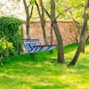 Ventaleen Blue Stripe Hammock hung between two trees.