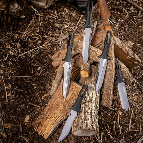 Five Nisaku Rikugatana 7.5-inch Japanese Stainless Steel Knives stuck in logs.