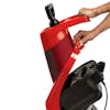 Person lifting up the top of the Sun Joe 15-amp Electric Wood Chipper in red to see inside.