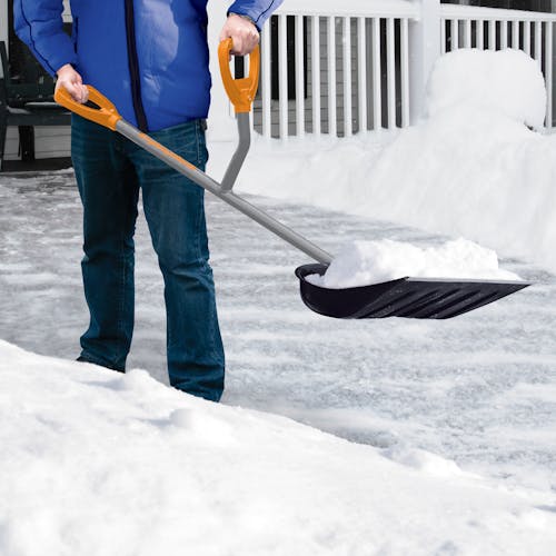Person using the ErgieSystems 18-inch Steel Shaft Impact Resistant Snow Shovel to pick up snow.