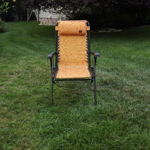 Front view of the 26-inch Amber Leaf Reclining Sling Chair on a lawn.