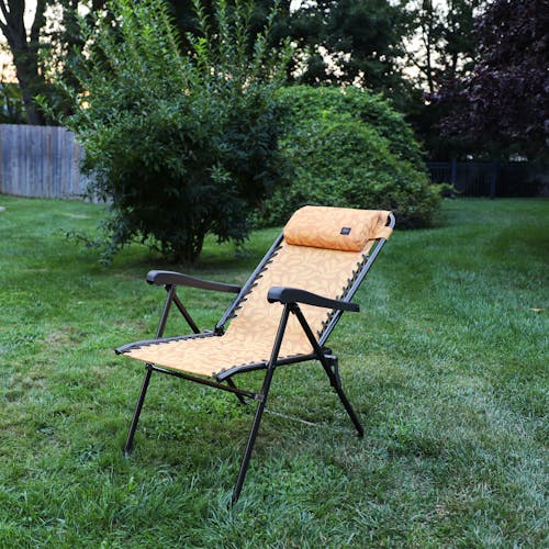 Angled view of the 26-inch Amber Leaf Reclining Sling Chair on a lawn.