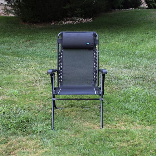 Front view of the 26-inch Black Reclining Sling Chair on a lawn.