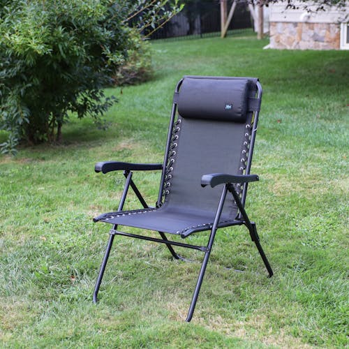 Angled view of the 26-inch Black Reclining Sling Chair on a lawn.
