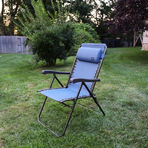 Angled view of the 26-inch Denim Blue Reclining Sling Chair on a lawn.