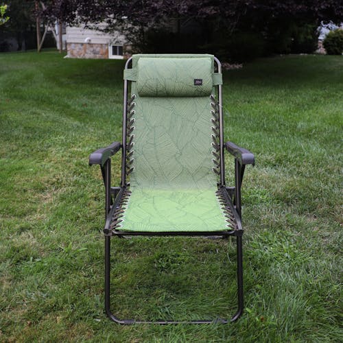 Front view of the 26-inch Green Banana Leaves Reclining Sling Chair on a lawn.