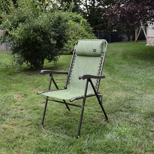 Angled view of the 26-inch Green Banana Leaves Reclining Sling Chair on a lawn.