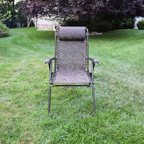 Front view of the 26-inch Brown Jacquard Reclining Sling Chair on a lawn.