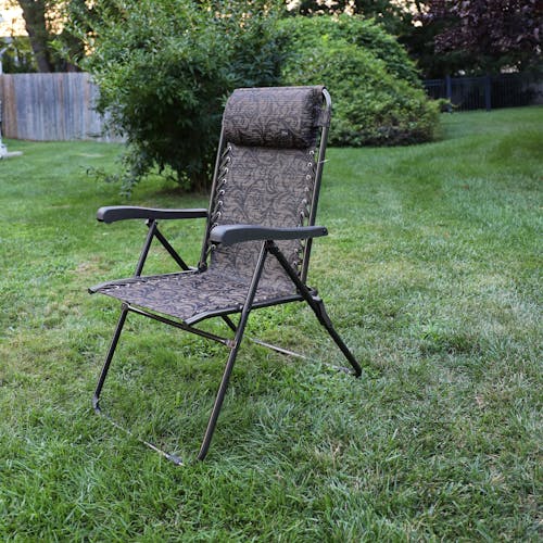 Angled view of the 26-inch Brown Jacquard Reclining Sling Chair on a lawn.
