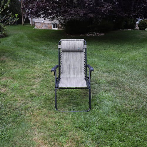 Front view of the 26-inch Platinum Reclining Sling Chair on a lawn.