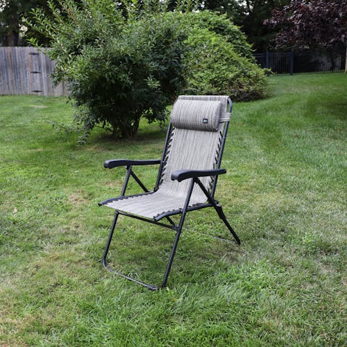 Angled view of the 26-inch Platinum Reclining Sling Chair on a lawn.