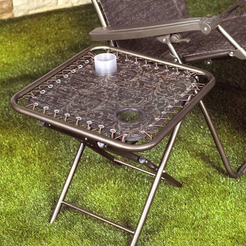 20-inch Brown Jacquard Folding Side Table on grass with a cup in the cup holder.