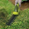 Sun Joe 2-in-1 Cordless Grass Shear and Hedger trimming a bush.