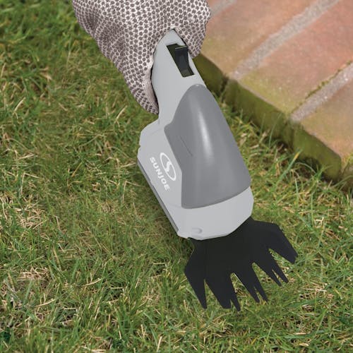 Sun Joe 7.2-volt Cordless Telescoping gray Grass Shear and Hedge Trimmer without the pole cutting grass with the shear.