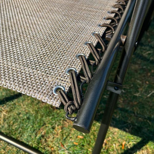 Close-up of the frame and bungees on the 26-inch Sand Reclining Sling Chair.
