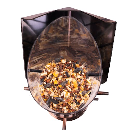 Close-up of the inside of the Bliss Outdoors 6-Port Bird Feeder filled with bird seed.