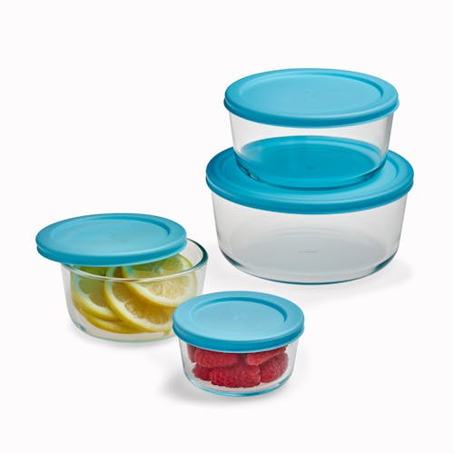 EatNeat 8-Piece Set of 4 Round Glass Storage Containers with lids. The two larger bowls are stacked and the smaller ones are filled with food.