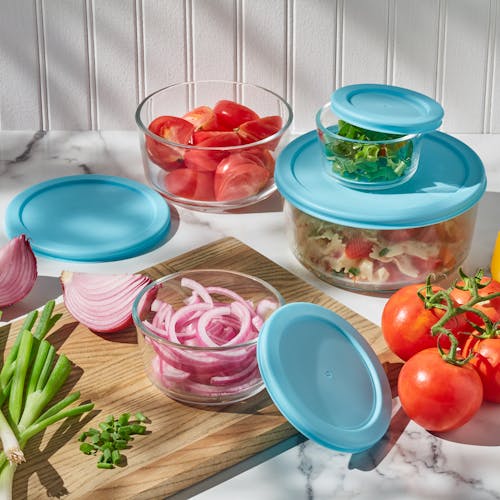 EatNeat 8-Piece Set of 4 Round Glass Storage Containers with lids filled with food on the kitchen counter.