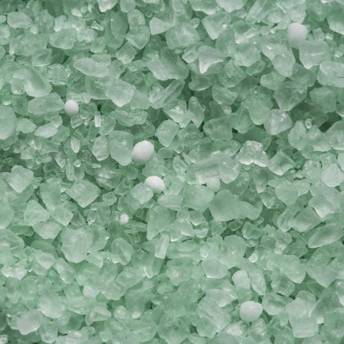 Close-up of the green Premium Enviro Blend Ice Melter.