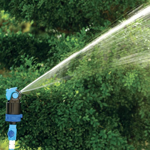 Close-up of the pest deterrent sprinkler spraying water.