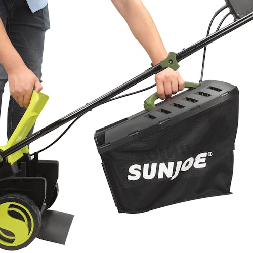Person attaching the collection bag to the back of the Sun Joe 12-amp 13-inch Electric Lawn Mower.