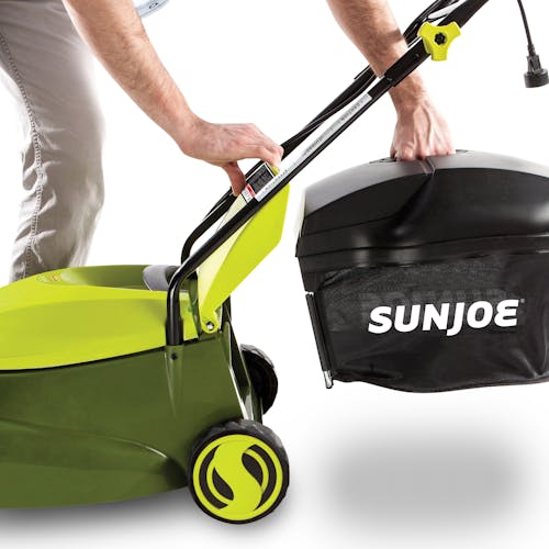 Person attaching the collection bag to the back of the Sun Joe 13-amp 14-inch Electric Lawn Mower.