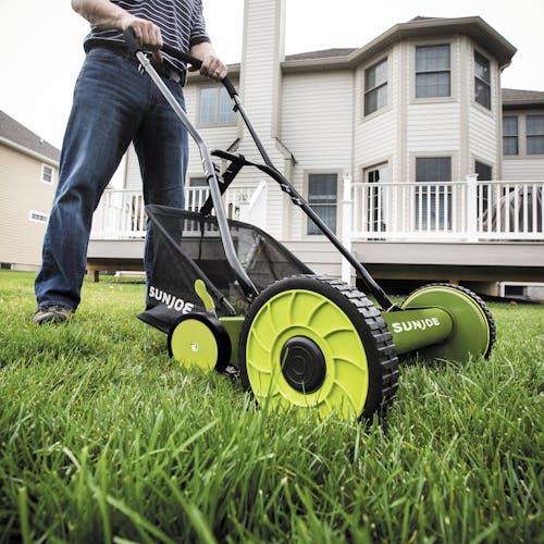 Sun Joe 20-inch Manual Reel Mower with Grass Catcher being used to mow a lawn.