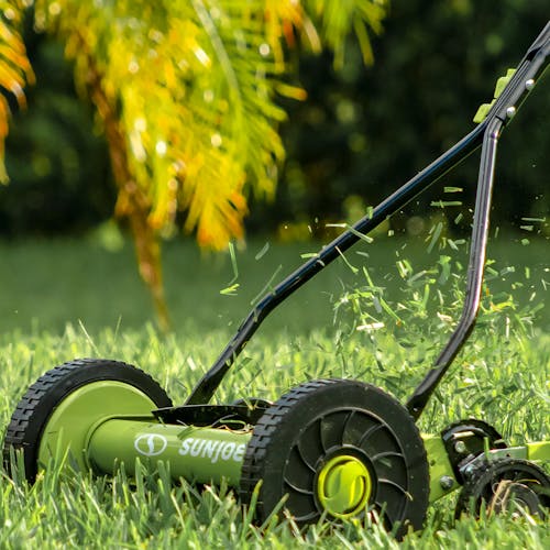 Sun Joe 14-inch Manual Reel Lawn Mower cutting grass.