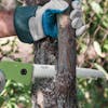Martha Stewart 7.3-inch Folding Pruning Saw cutting bark off a tree.