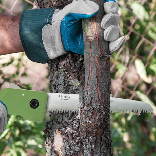 Martha Stewart 7.3-inch Folding Pruning Saw cutting bark off a tree.