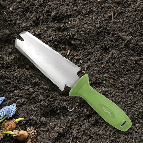 Martha Stewart Hori-Hori Garden Knife laying in soil.