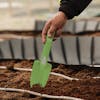 Trowel being dug into soil.