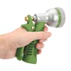 Person squeezing the lever on the Martha Stewart Adjustable Hose Nozzle.