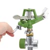 Person adjusting the trip lever on the Martha Stewart Metal Impulse Sprinkler with spike.