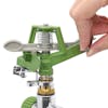 Person adjusting the spray on the Martha Stewart Metal Impulse Sprinkler with spike.