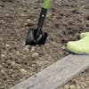Martha Stewart Telescoping Garden Trowel being dug into soil.