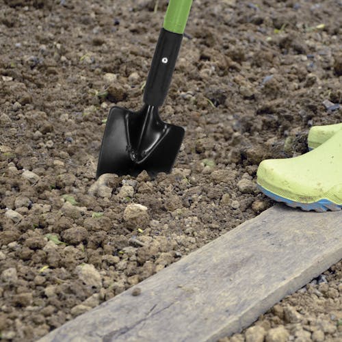 Martha Stewart Telescoping Garden Trowel being dug into soil.