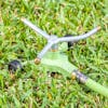 Martha Stewart Metal 3-Arm Rotating Sprinkler on grass.